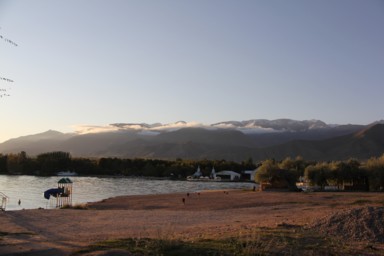 イシククル湖の反対にも雲が流れる高い山脈がある景色