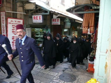 エルサレムの旧市街を黒装束の衣装で行進する人々