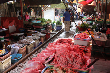 メークロン市場の線路の真横で生肉を売っている風景