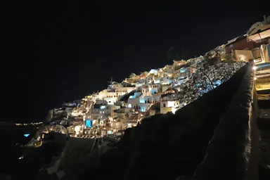 サントリーニ島のイアの夜の家々の光で地形のシルエットを想像できる景色